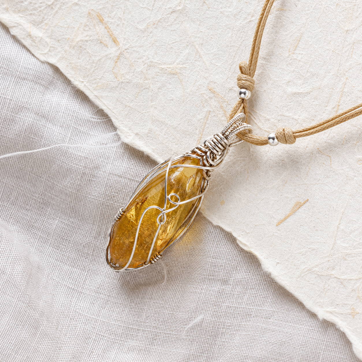 Citrine amber wire wrapped energy stone pendant on linen and handmade paper
