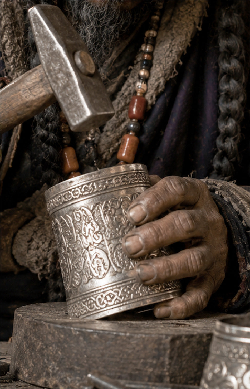 Hands holding sacred metal ritual object