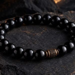 Close detail of Obsidian Night Shield Bracelet on dark stone