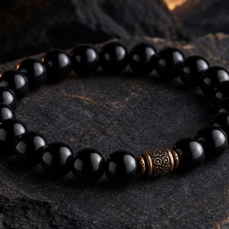 Close detail of Obsidian Night Shield Bracelet on dark stone